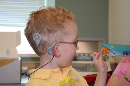 A child with a Cochlea implant. Photo (unchanged): Ryan Poole